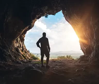 An image of a guy going inside a cave