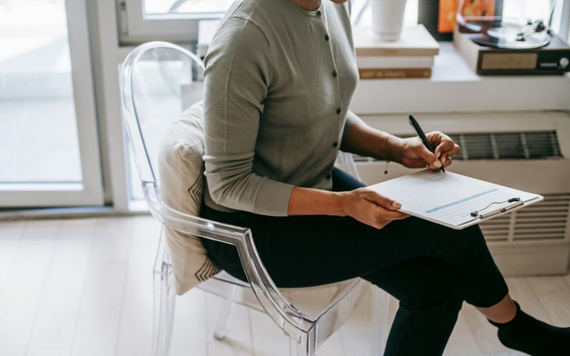 Therapist taking notes during private anxiety therapy session.