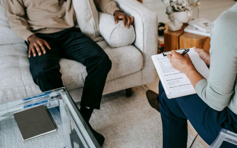 Therapist and client in conversation during counseling session.