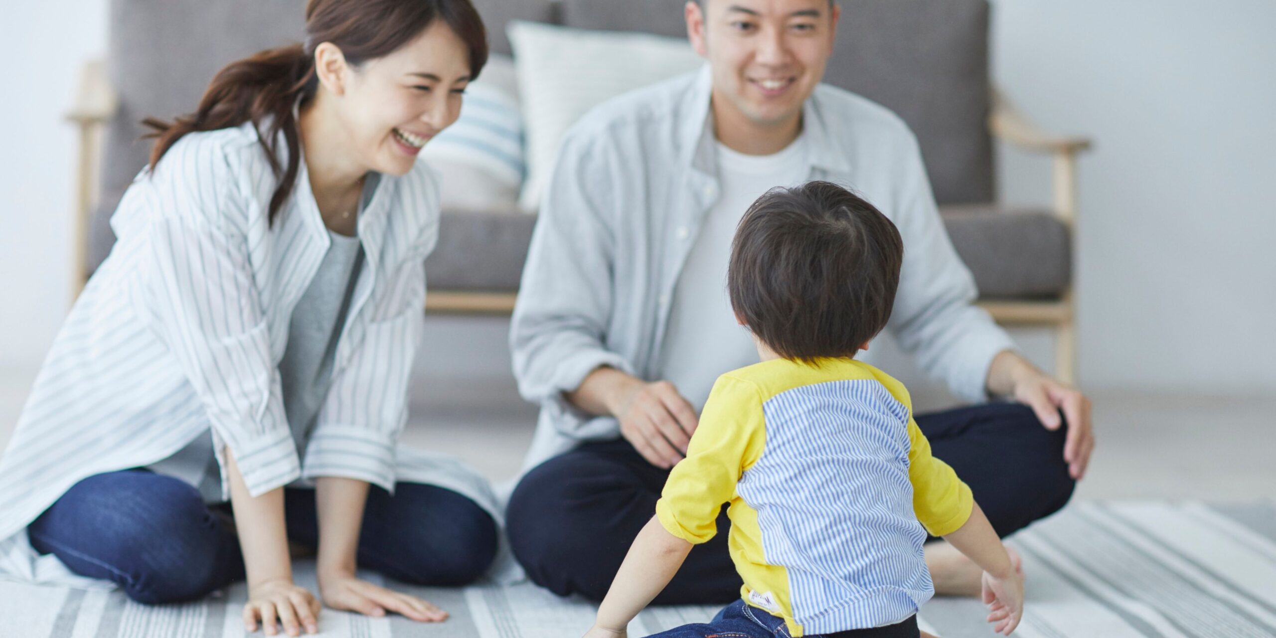 Parents happily playing with their toddler