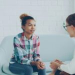 Therapist talking to a child while in session