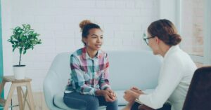 Therapist talking to a child while in session