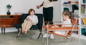 Kids with counselor having a therapy session indoors, fostering emotional support.